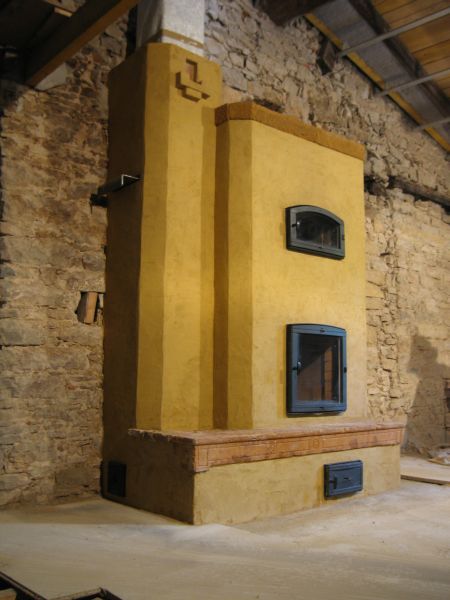 Contraflow heater rendered with lime sand mix, With red sandstone trim.