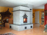 A down draught contra-flow masonry heater faced in Stanstead granite.