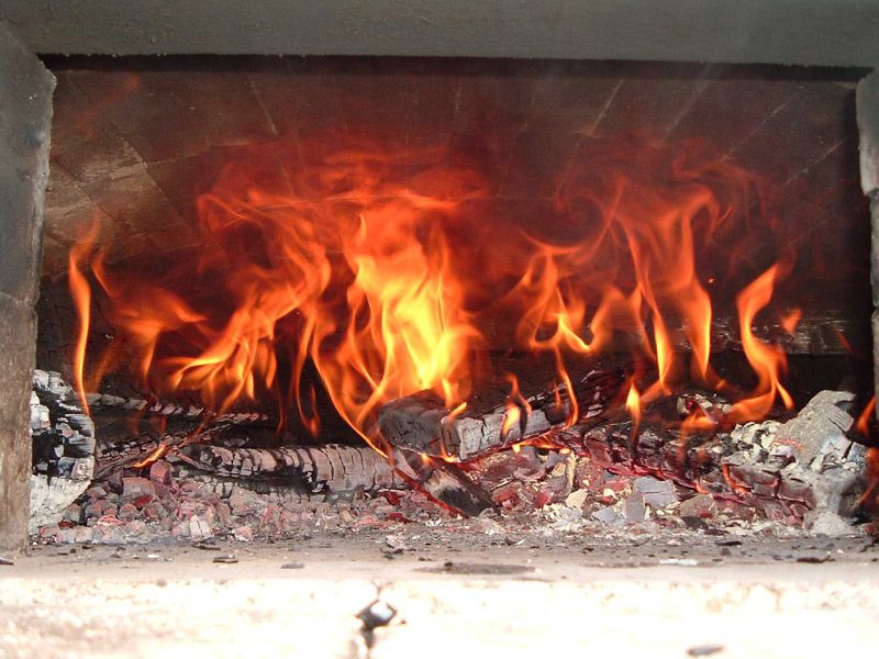 View of flame caused by the secondary ignition of gases liberated by the wood load