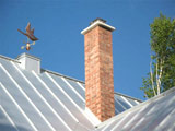 The chimney is finished with an air entrained concrete cap, with drip line, and stainless steel rain hat.